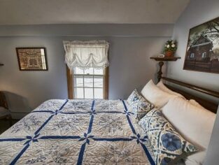 Room 14 with queen size bed and blue accents