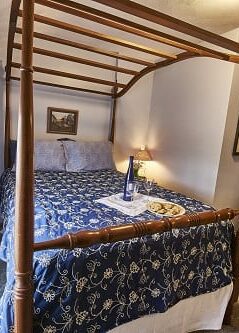 Room 15 with full size bed and blue accents