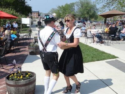 Man and lady in period dress dancing at festival