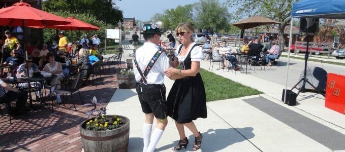 Man and lady in period dress dancing at festival