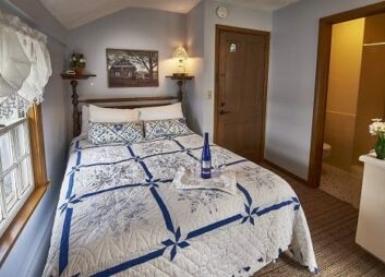 Room 14 with queen size bed and blue accents