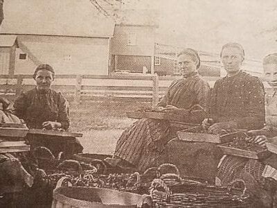 historical photo of ladies and girls preparing vegetables